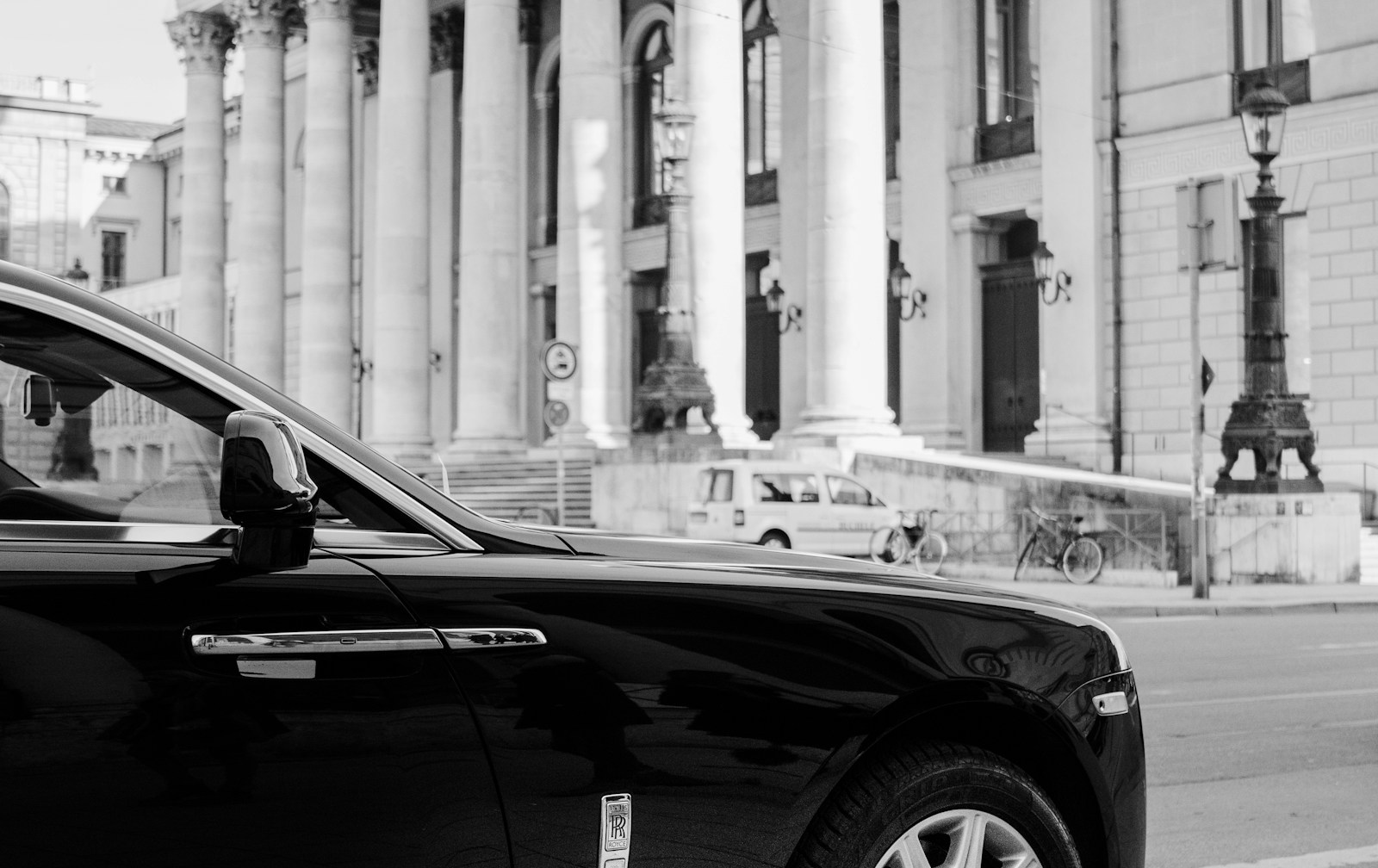 Chauffeured car waiting outside a European facade